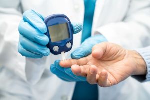 A doctor checking a patient's blood sugar level. 