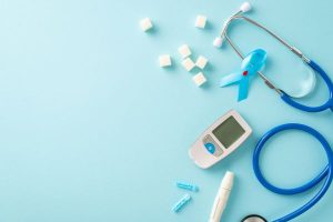 Medical tools and light blue ribbons for Diabetes Awareness Month.