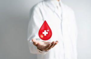 Doctor in a white coat with a blood donation
