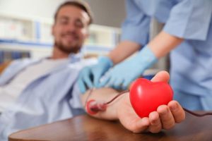 Young man making a blood donation in a hospital