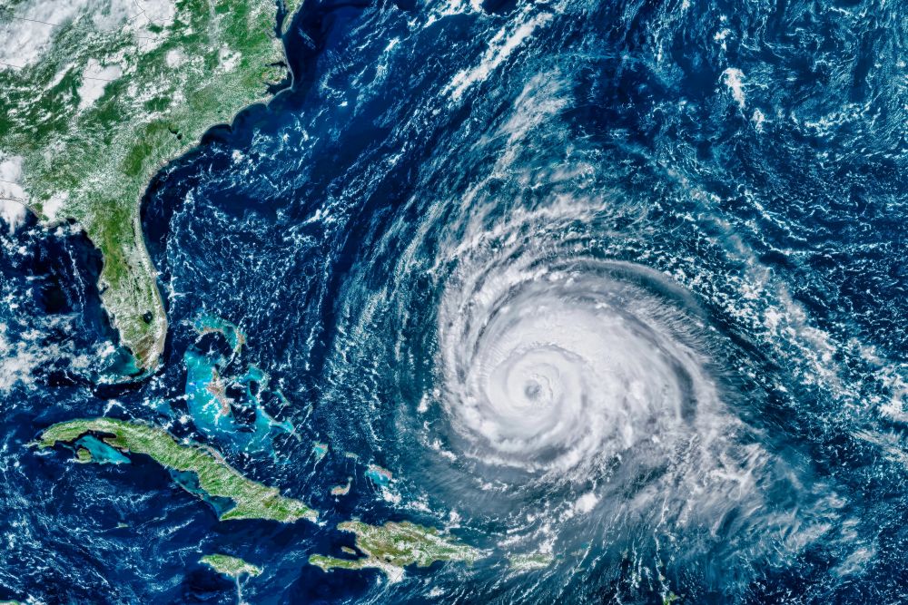 A satellite image of a hurricane in the Atlantic ocean, moving towards the Florida coastline.